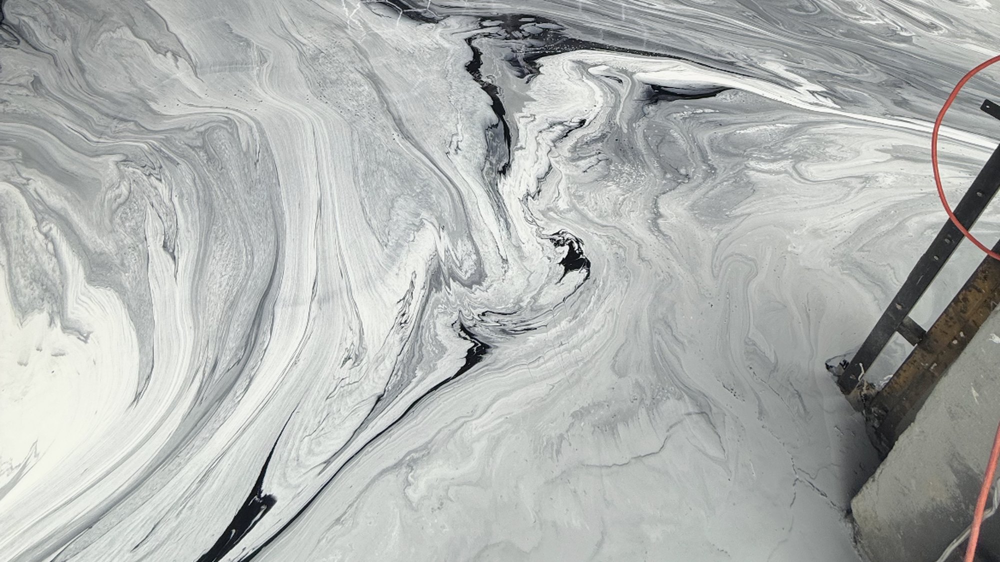 Marble-look metallic epoxy floor in a bright room