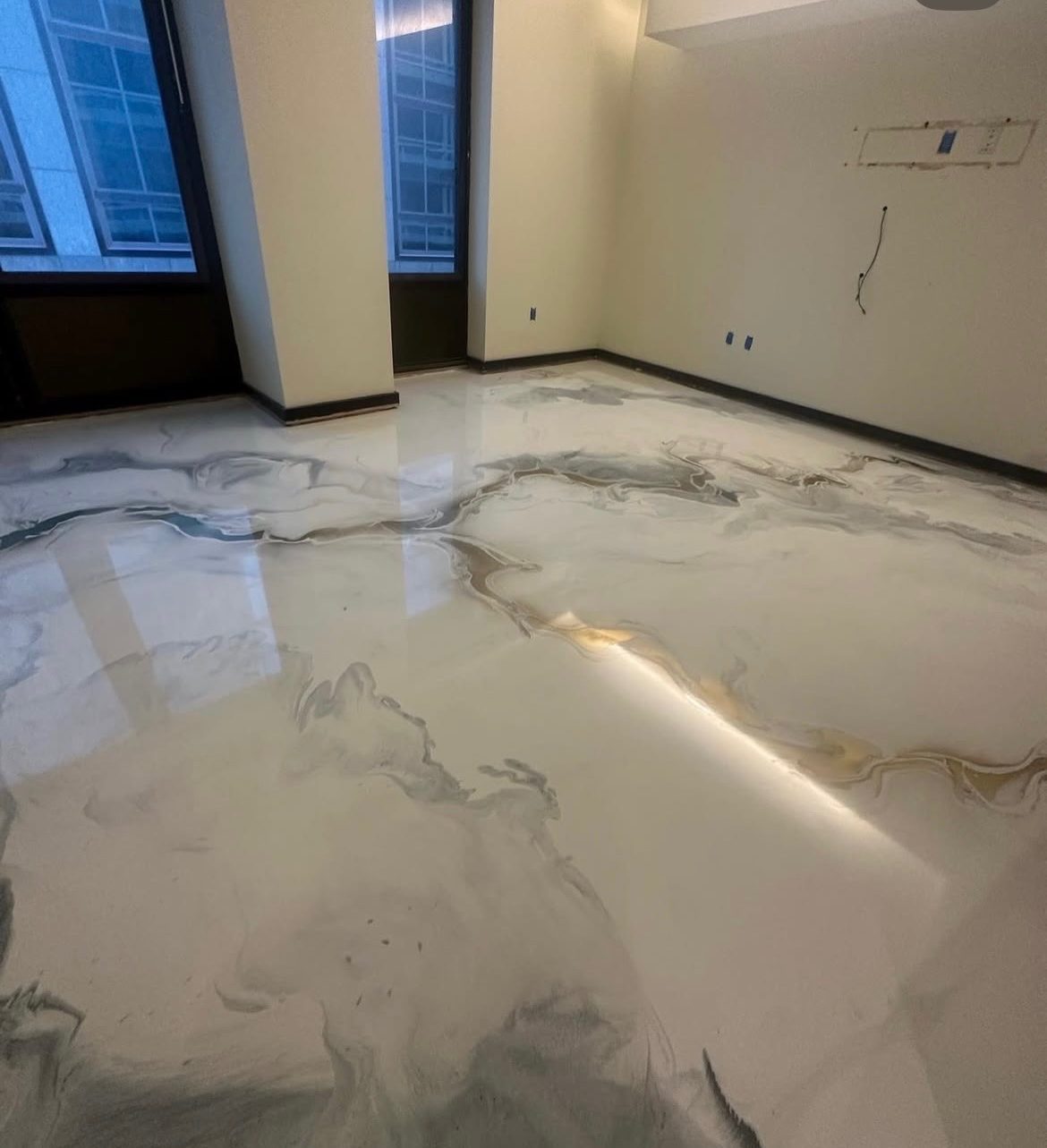White and grey marbled metallic epoxy floor in a living space