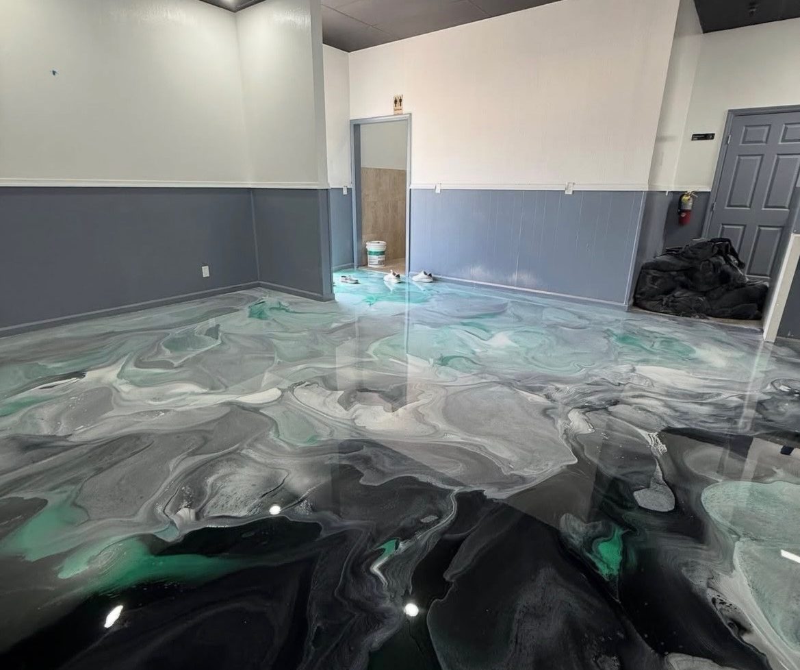 Black, teal and white metallic epoxy floor in a commercial room