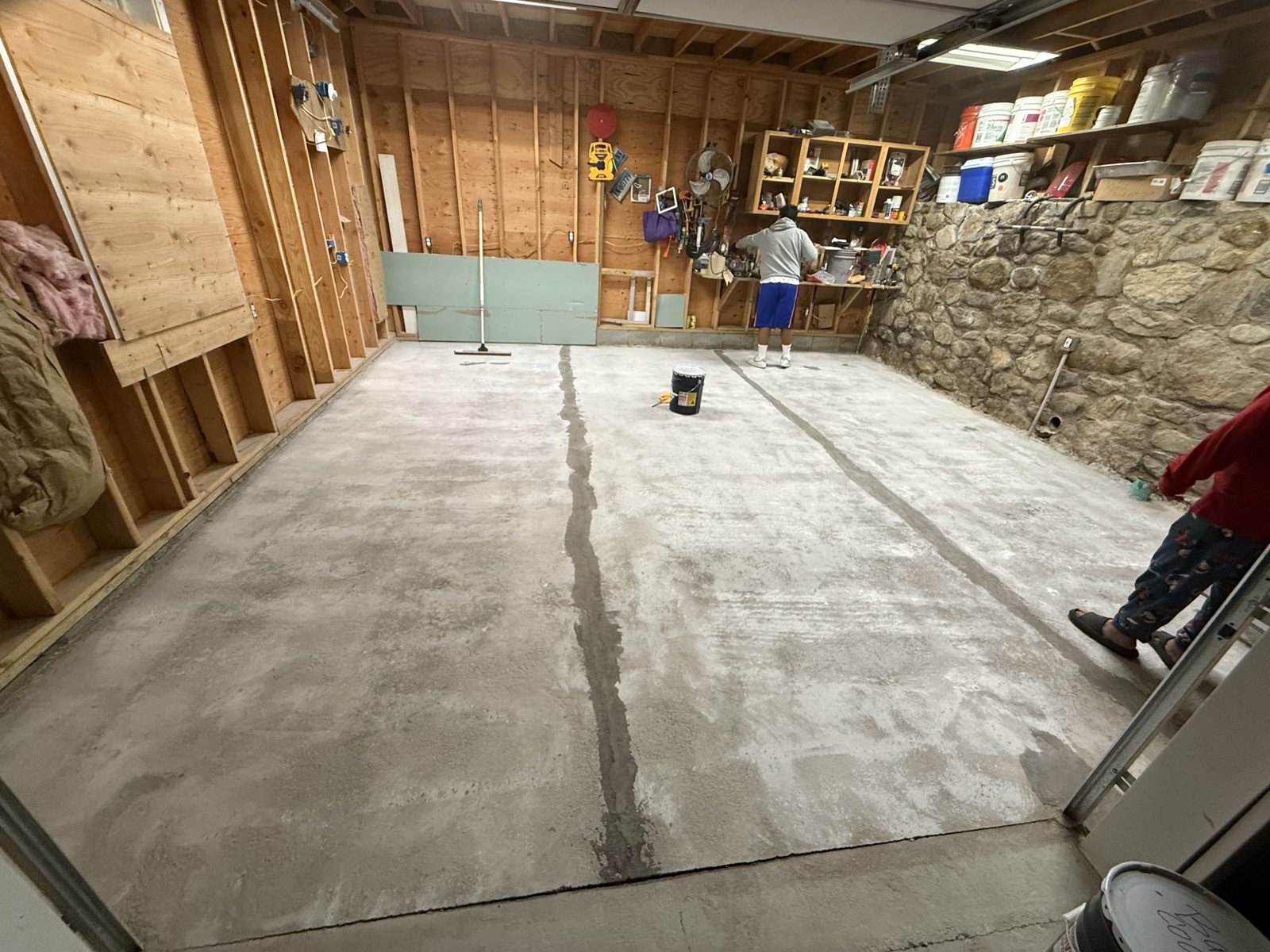 Bare cracked concrete basement slab before the metallic floor