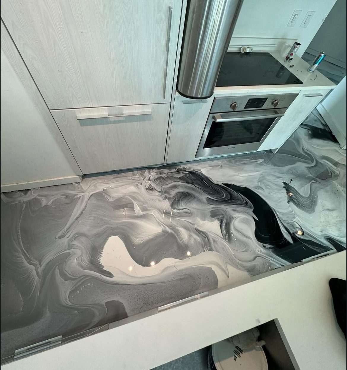 The same pearl metallic floor carried seamlessly into the kitchen