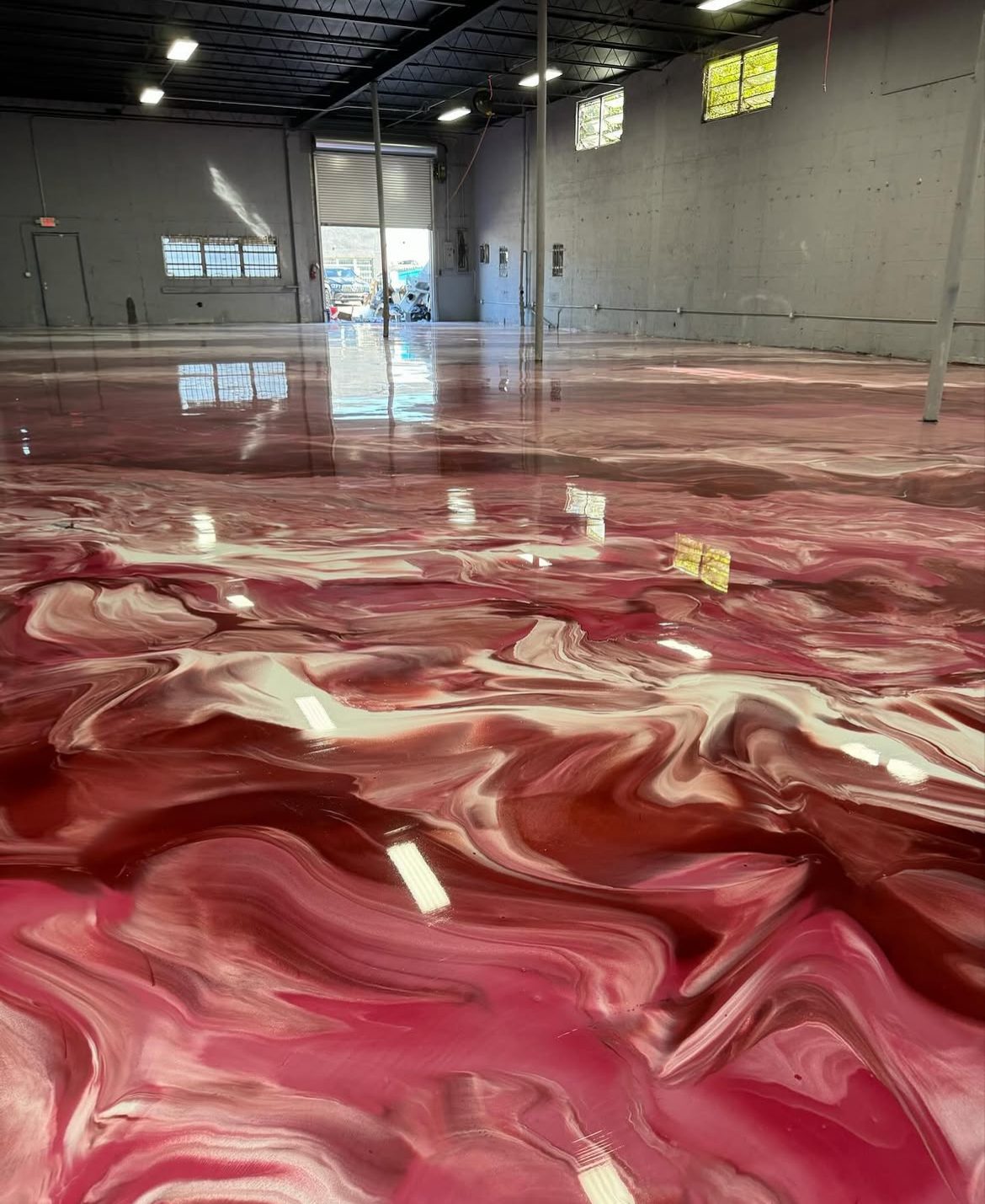 Industrial epoxy floor poured across a warehouse bay