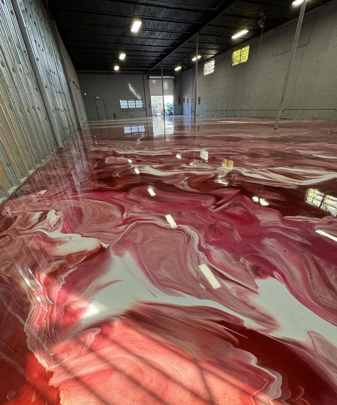 Sealed epoxy warehouse floor under shop lighting